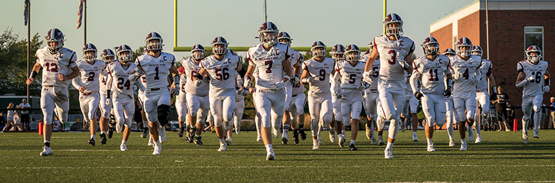 Orchard Park Quakers Football team hitting the field Orchard Park Quakers Football team hitting the field